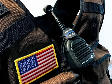 US flag patch and radio microphone on a carrier