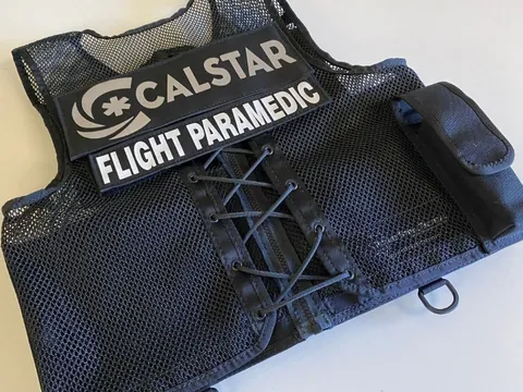 Black mesh air medic vest with a CALSTAR Flight Paramedic panel