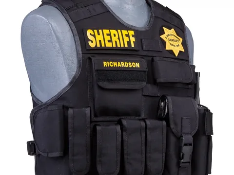 Black external armor carrier with a SHERIFF panel, star badge and pouches